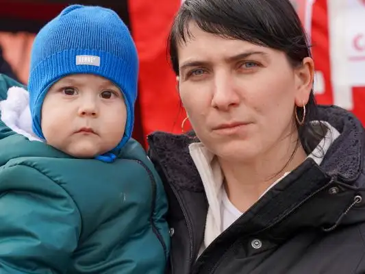Ukraine refugees - a mother and her son cross into Poland.